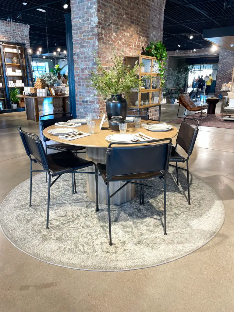 industrial metal and leather chairs around circular dining room table