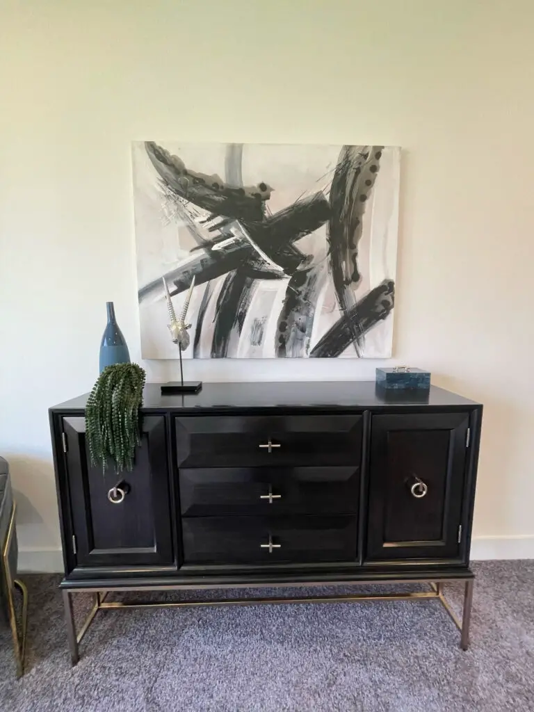 modern abstract painting above modern bedroom dresser 