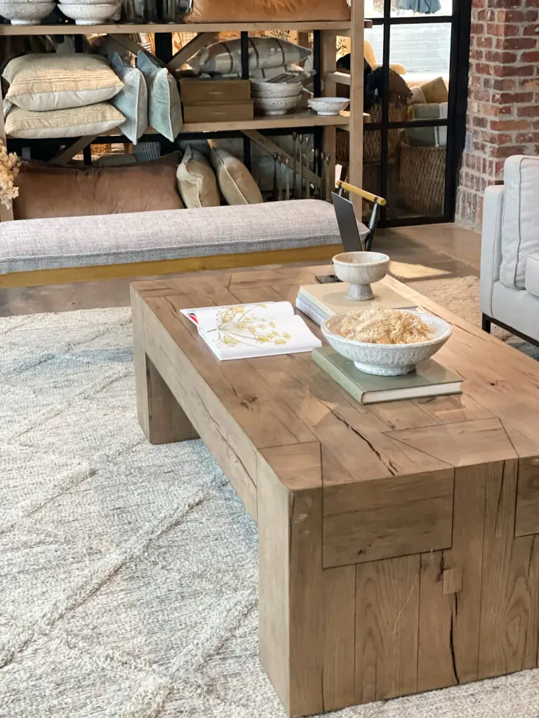 natural wood coffee table in coastal farmhouse living room design