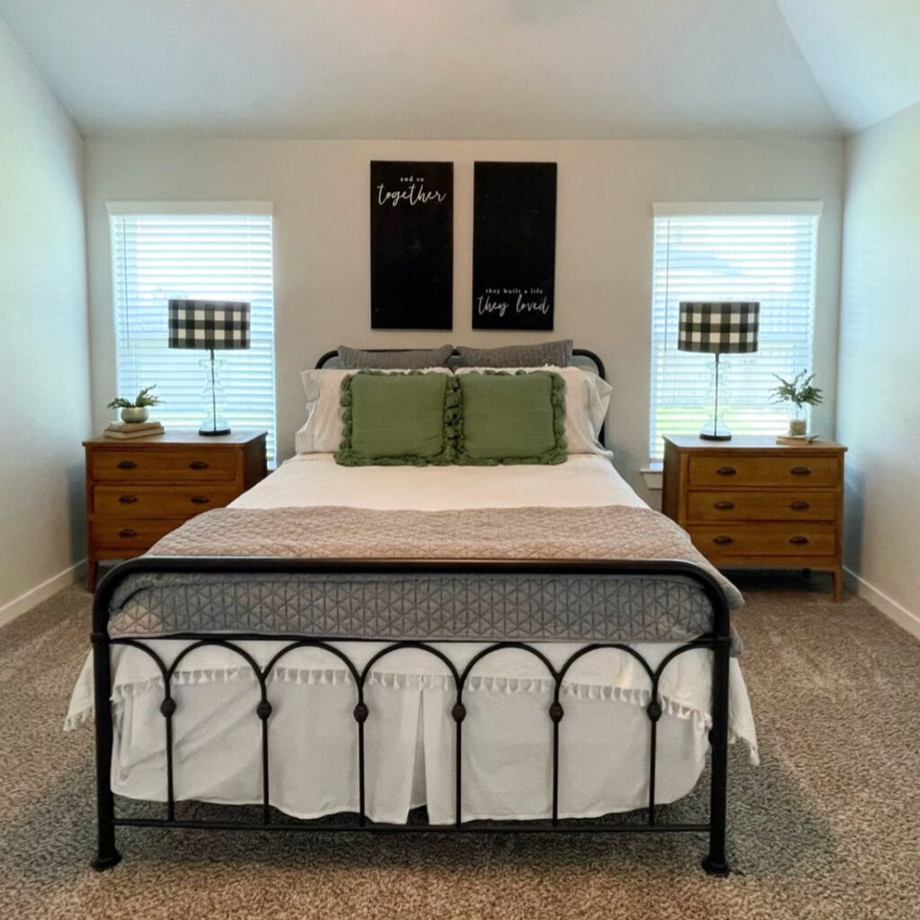 black, white, and green modern farmhouse bedroom with wrought iron bed frame