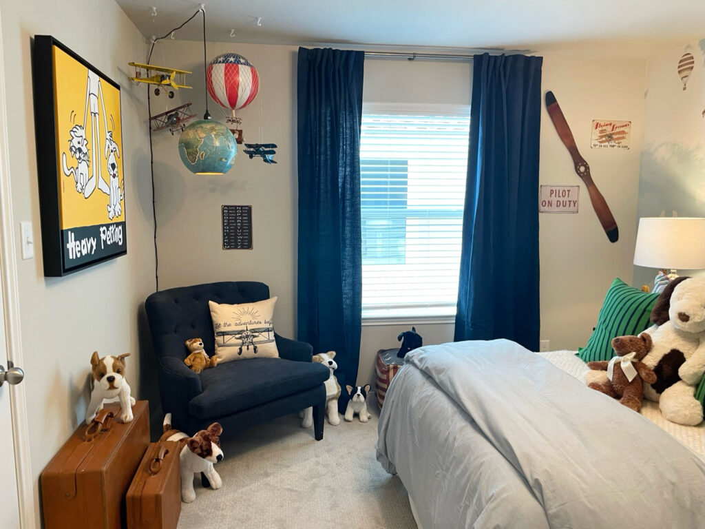 little boys travel themed bedroom filled with toys and decorative objects