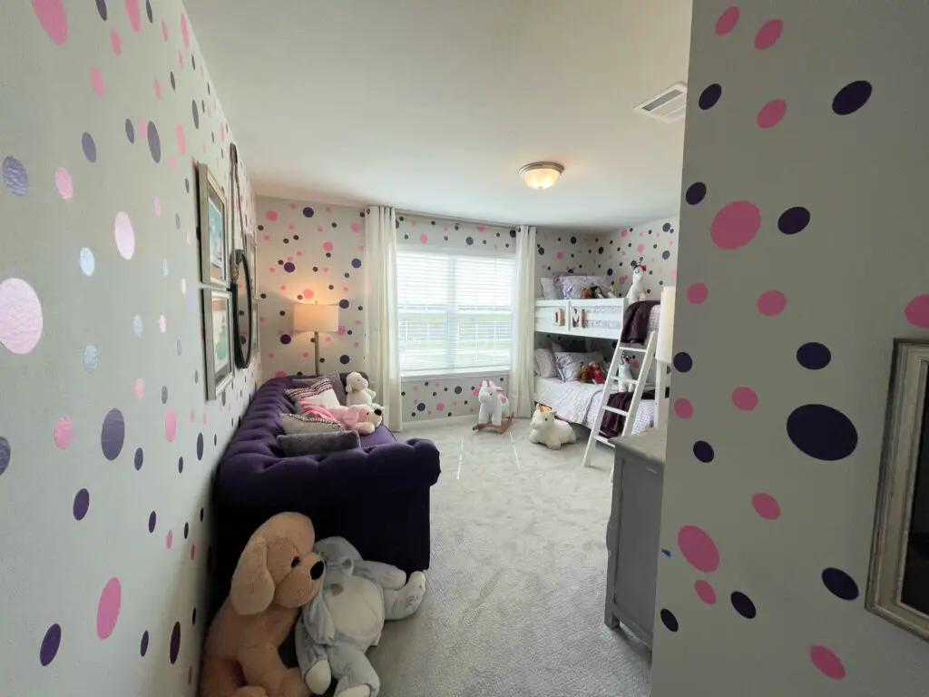grey walls with peel and stick polka dots in purple and pink little girl's room